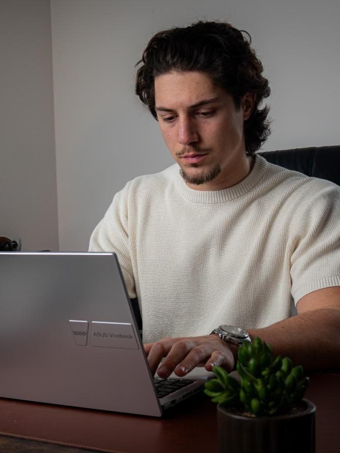 Rafe Baker, Mortgage & Protection Adviser, working at his desk in the Lifestyle Choices office
